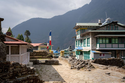 Houses in city against sky