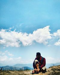 Man sitting against sky