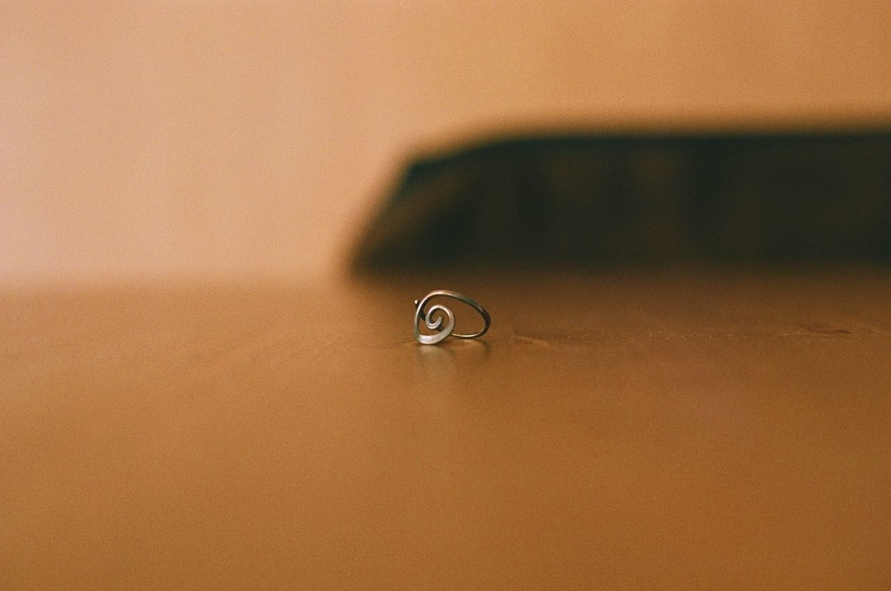 CLOSE-UP OF WEDDING RINGS ON METAL TABLE