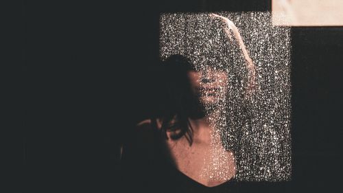 Woman standing in water at night