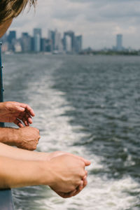 Midsection of man in sea against sky