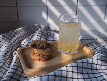 Take a break relaxing time with cookie chocolate chip and yuzu orange juice in wooden tray. 