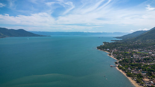 High angle view of townscape by sea against sky