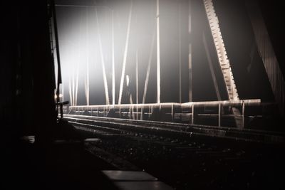 Illuminated bridge against sky at night