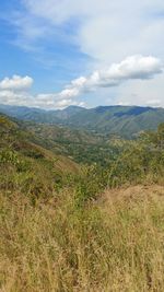 Scenic view of mountains against cloudy sky