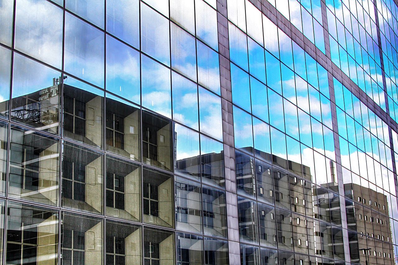 architecture, building exterior, built structure, modern, glass - material, office building, low angle view, city, reflection, window, building, skyscraper, blue, glass, sky, tall - high, day, tower, city life, outdoors