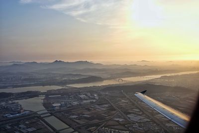 Aerial view of cityscape against sky during sunset