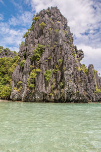 Scenic view of rocks in sea against sky