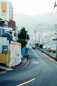 Vehicles on road against buildings