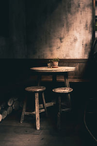 Empty chairs and table against wall at home