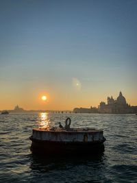 Scenic view of sea against clear sky during sunset