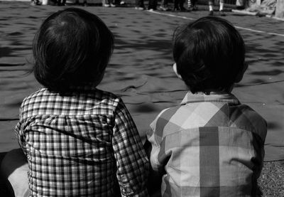 Rear view of boys sitting