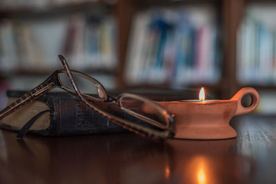 Close-up of illuminated candles on table