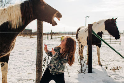 Horse and girl laughing.