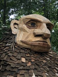 Low angle view of statue against trees