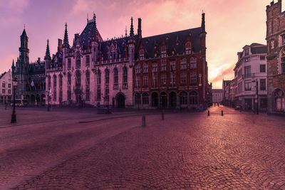 Buildings in city at sunset