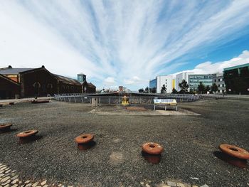 Surface level of street amidst buildings against sky