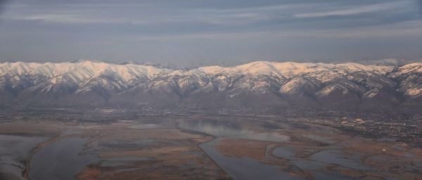 Wasatch front rocky mountain range aerial snow capped peaks winter urban salt lake city utah usa