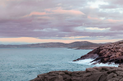 Scenic view of sea and mountains against sky
