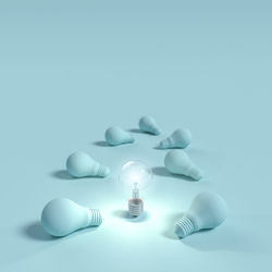 Close-up of light amidst bulbs on blue background