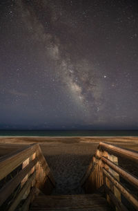 Steps at beach against star field