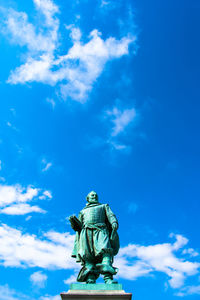 Low angle view of statue against blue sky