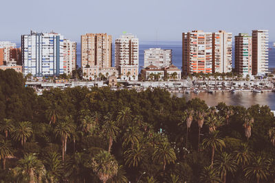 View of city buildings against clear sky