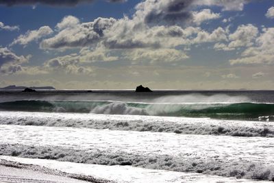 Scenic view of sea against cloudy sky