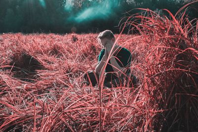 Full length of woman with red light painting on field