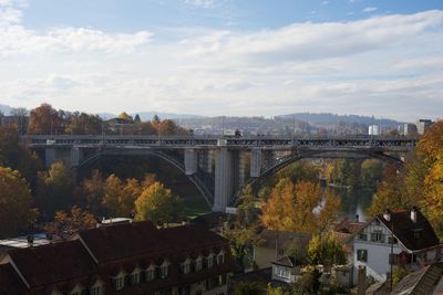 Bridge over river against sky during autumn