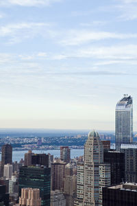 Skyscrapers against cloudy sky