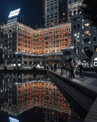 High angle view of illuminated city buildings at night