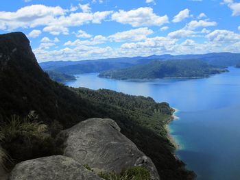 Scenic view of sea and mountains against sky