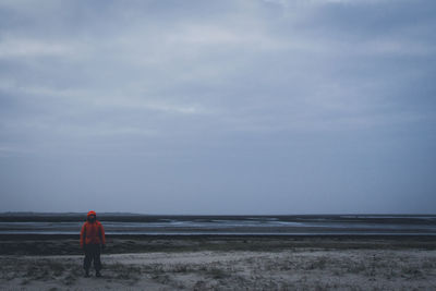 Full length of man standing against sea during sunset