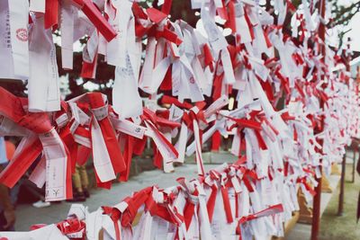 Close-up of paper wishes tied at japanese temple