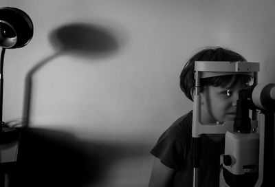 Portrait of boy looking at ophthalmic lens