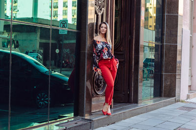 Woman standing against building in city