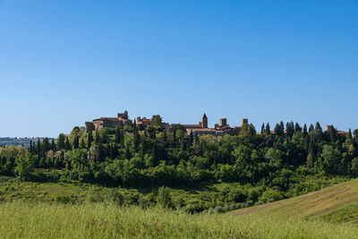 Panoramic view of townscape against clear blue sky