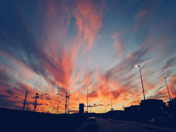 Low angle view of dramatic sky over road during sunset