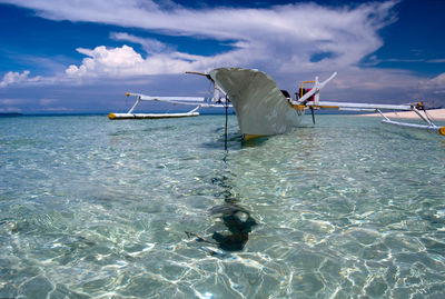 Clear tranquil water and traditional boat on kokoya island, morotai, north maluku, indonesia