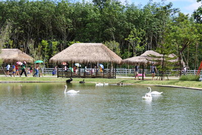 Group of people on lake against trees