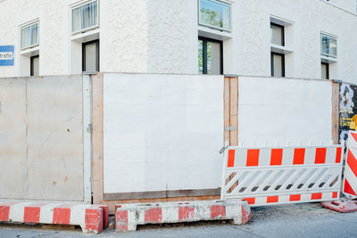 Barricades on street against building