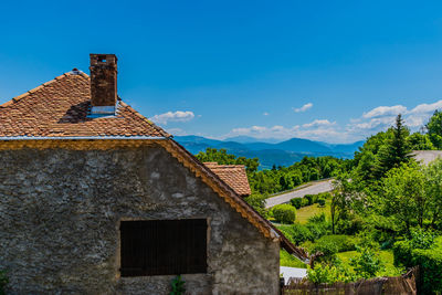 Low angle view of old building against blue sky