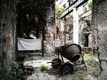 Abandoned built structure against trees