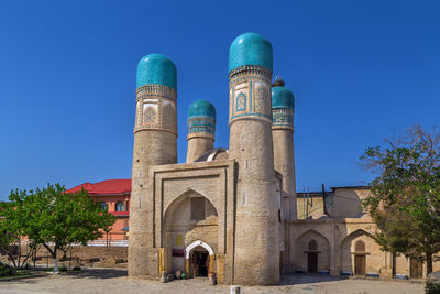 Low angle view of historic building against clear blue sky