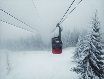 Overhead cable car against sky during winter