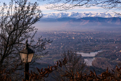 Scenic view of lake against sky in city