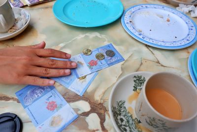 High angle view of woman holding food on table