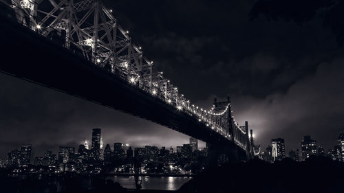 Illuminated cityscape against sky at night