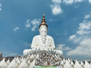 Low angle view of statue against building against sky